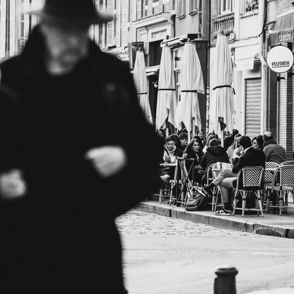 Terrasse animée d’un café dans le centre-ville de Toulouse, parfaite pour un dîner en amoureux avant une nuit romantique en Love room Toulouse.